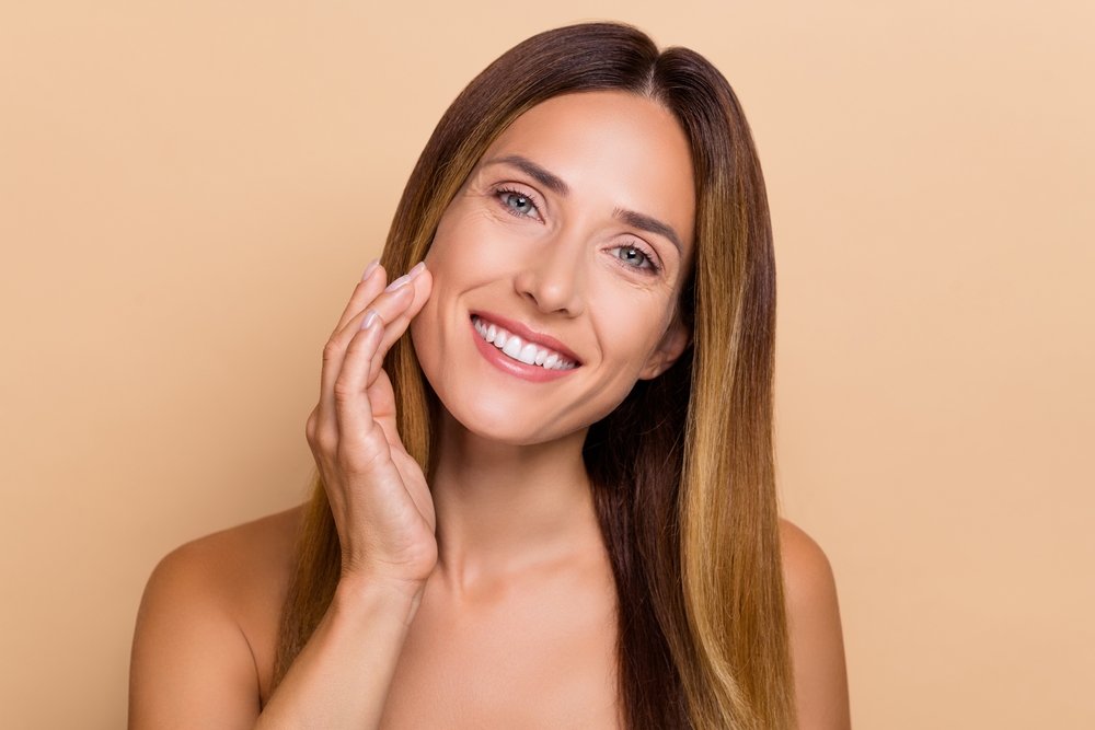 Attractive woman in her 40s loves her healthy, glowing skin after resurfacing.